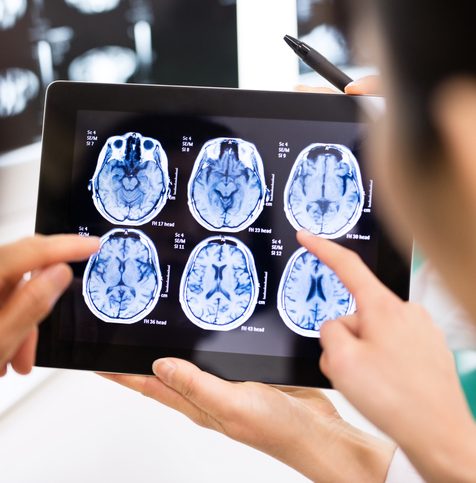 Doctor and patient using digital tablet in hospital