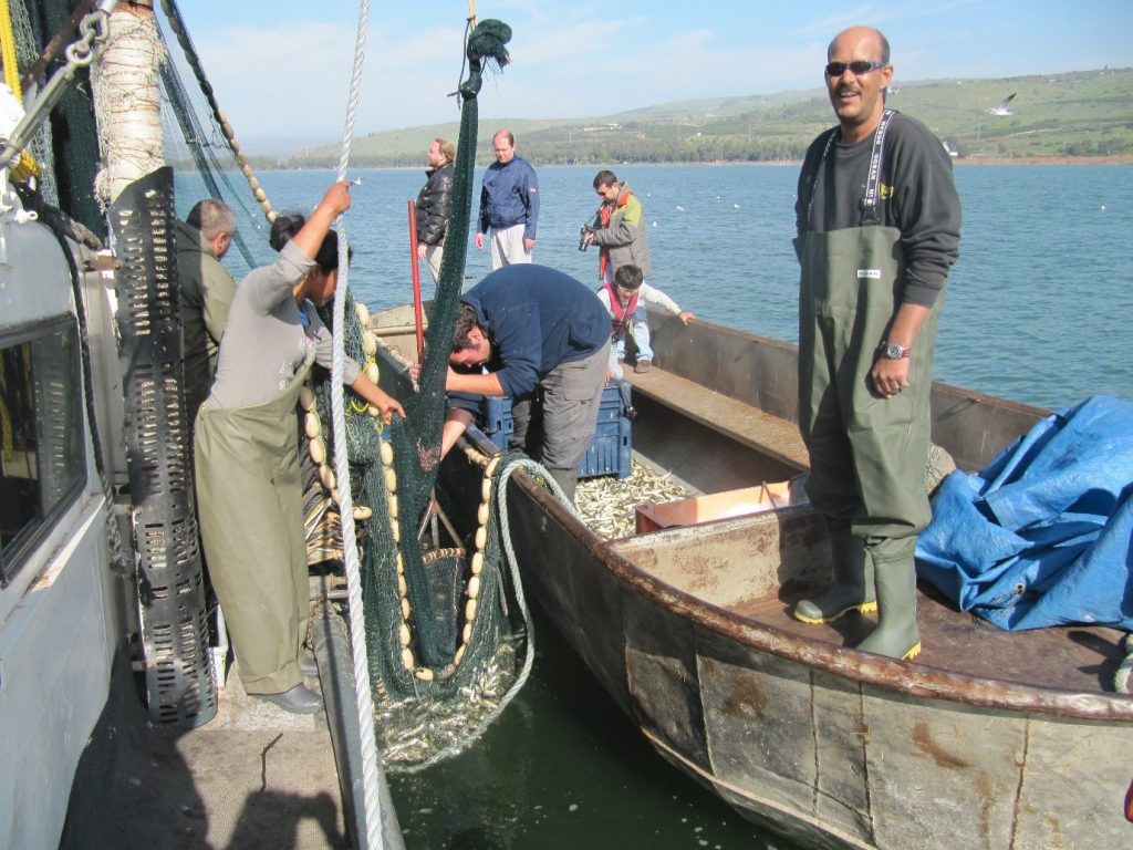 The late Tomer Borovsky (right) with the fishing team from Kibbutz Ein Gav aboard Captain Menachem Lev's boat 'Gil'.